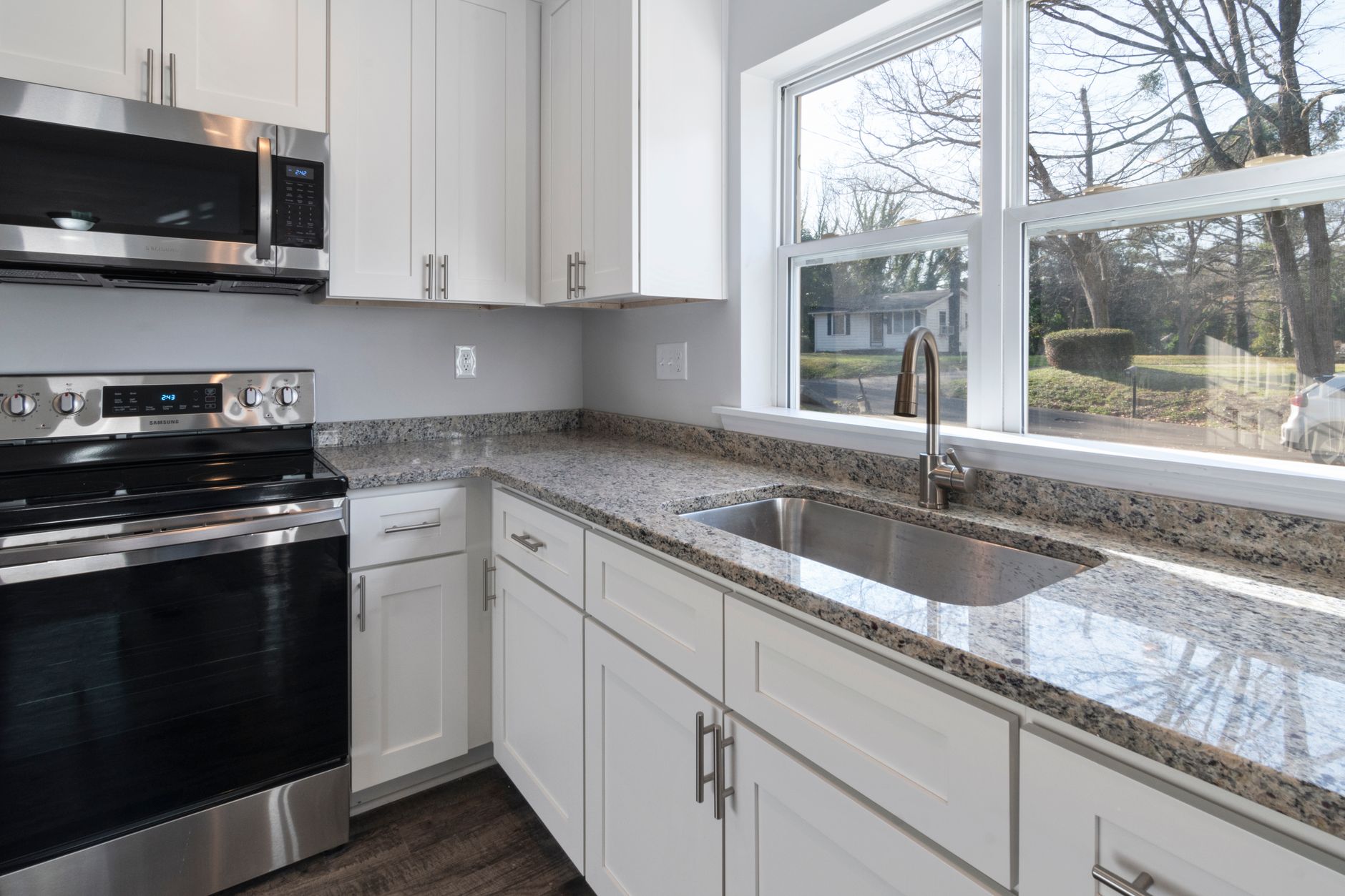 Bright kitchen showcasing granite countertops, stainless steel appliances, and large windows in Scottsdale, AZ